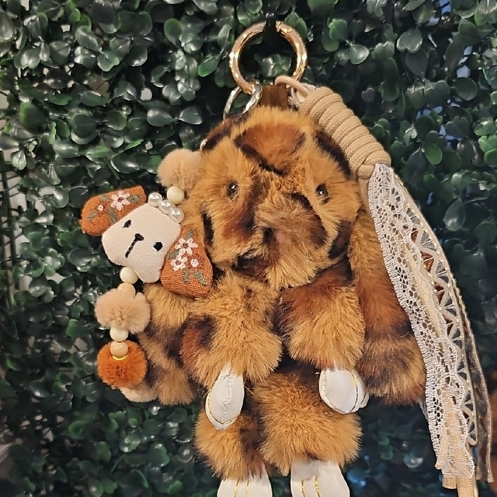 Adorable fluffy rabbit backpack charm featuring a soft leopard-print design